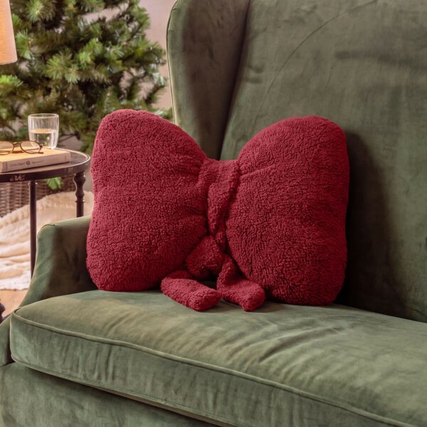 Coussin Brionella en forme de nœud avec tissu bouclé duveteux